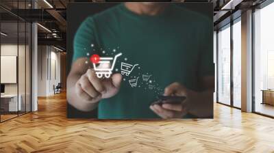 Man using a smartphone with online shopping, marketplace website with virtual interface of online Shopping cart part of the network, Online shop business with selecting shopping cart. e-commerce. Wall mural