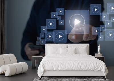 Online movie stream with mobile phone. Video on demand technology with person touching play button on virtual screen to watch online VOD streaming of movie, TV on smartphone with video player service. Wall mural