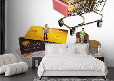 Miniature figure businessman standing on credit card and sitting on stacked coin and cart on back. Concept of spending with credit card or cash. Wall mural