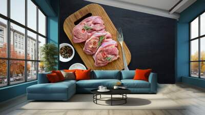 Raw turkey steak meat with bone on wooden board background Wall mural