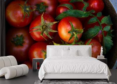 red ripe tomatoes in metal bowl on old red wooden table in garden on sunny day Wall mural