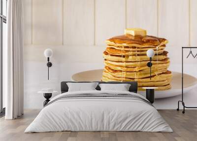 Stack of pancakes with butter and honey on white background Wall mural