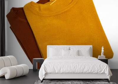 Women's clothing set. Brown and yellow sweaters isolated on background. Autumn look. Clipping path. Top view Wall mural