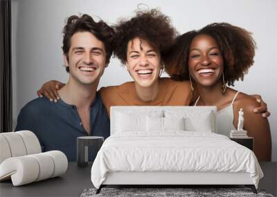 Photograph of three friends posing together in a medium shot, smiling, and looking at the camera against a white background Wall mural