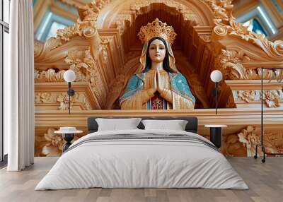 A detailed carved wooden statue of the Virgin Mary with hands in prayer displayed inside a church Wall mural