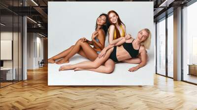 good looking positive cheerful girls with ideal perfect slim bodies in fashion swimsuits posing to the camera, full length photo, health care, beauty Wall mural