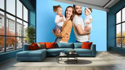 Happy family with two adorable children looking at camera isolated on blue background. close up photo. isolated blue background. lifestyle.love Wall mural