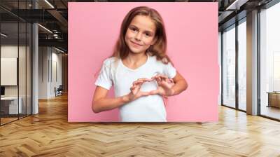 Portrait of young smiling beautiful blonde girl making heart with palms. close up portrait, isolated pink background, body language. reaction, love, positive feeling and emotion Wall mural