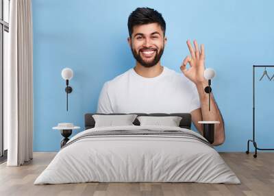 positive attractive Arab young man showing ring gesture with fingers.close up portrait, good job, agreement concept. I am OK, approval. studio shot.guy being satisfied with suggestion Wall mural