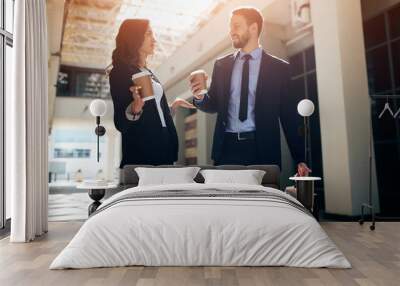 young woman and man in fashion formal clothes making conclusion, drinking coffee after workshop. close up photo Wall mural