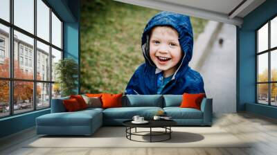 toddler boy playing in the rain Wall mural