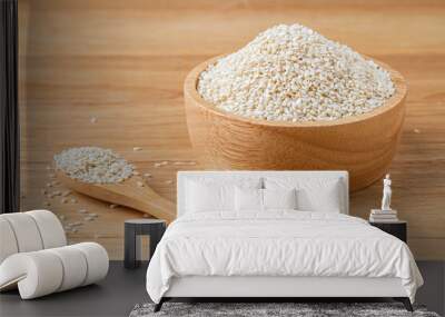 white sesame seeds in wooden spoon and wooden bowl on table,organic food concept. Wall mural