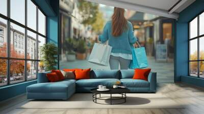 Back view of a young woman walking down an urban street carrying shopping bags and wearing sneakers The modern shopaholic is always on the go : Generative AI Wall mural