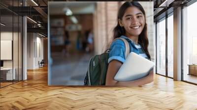 Beautiful latin teen girl carrying a laptop to junior high school looking happy showing her laptop while doing homework : Generative AI Wall mural