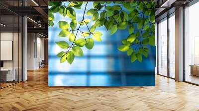 Ecofriendly building in the modern city Green tree branches with leaves and sustainable glass building for reducing heat and carbon dioxide Office building with green environment Go gr : Generative AI Wall mural