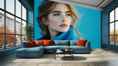 fashion portrait of young elegant woman in blue coat on blue background : Generative AI Wall mural