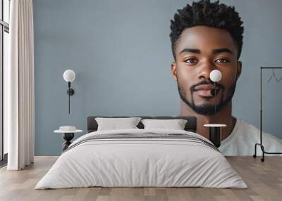 Headshot of attractive serious African student with small beard and moustache dressed in casual tshirt looking at camera with confident and thougthful expression on his face standing a : Generative AI Wall mural