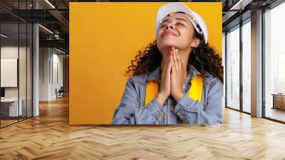 Hispanic girl wearing builder uniform and hardhat smiling with hands on chest with closed eyes and grateful gesture on face health concept : Generative AI Wall mural