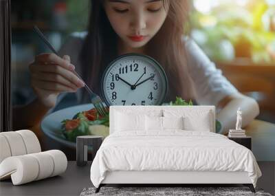 Intermittent fasting with clock health asian young woman girl weight loss eating green fresh vegetable salad on dish plate with eat healthy of breakfast food in morning lunch on a tabl : Generative AI Wall mural