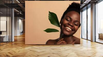 Shirtless black woman laughing at camera posing with plant leaf isolated over beige background : Generative AI Wall mural