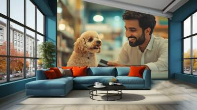 Smiling arabian man looking at poodle while paying with credit card in pet shop : Generative AI Wall mural