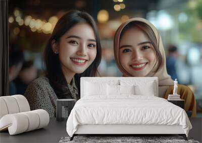 Two young pretty Indonesian entrepreneur woman smile at the camera while holding smartphone against business meeting with clients on a cafe Diversity business people concept : Generative AI Wall mural