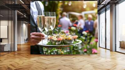 Waiter holding a tray with champagne glasses and appetizers at an outdoor garden event : Generative AI Wall mural