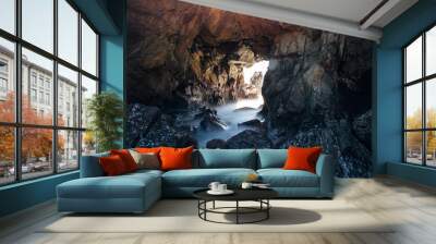 Dramatic rock tunnel on Pacific coast Wall mural