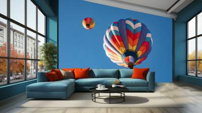 Two hot air balloons flying high in the blue sky Wall mural