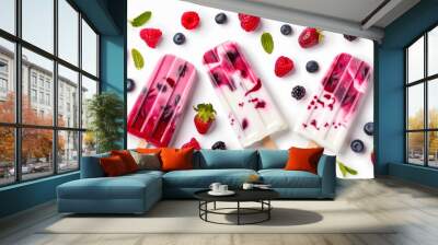 Colorful berry popsicles made with fresh strawberries, blueberries, and raspberries on a white background. Refreshing and delicious summer treats. Wall mural