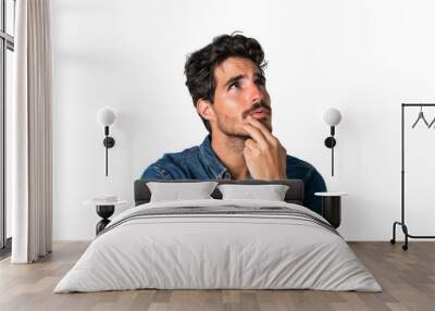 Portrait of a curious man thinking and looking up with hand at chin, isolated on transparent background
 Wall mural