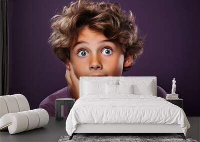 Portrait of attractive cheerful cute smiling kid copy space, isolated over violet purple color background Wall mural