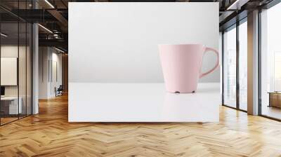 pink coffee mug on white table Wall mural