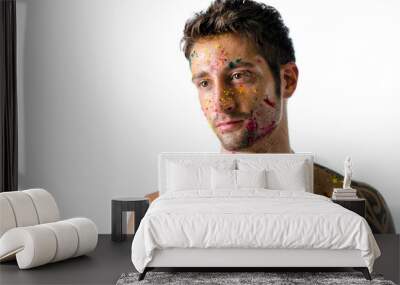 Athletic young man shirtless, skin painted with Holi colors Wall mural