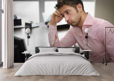 Tired or frustrated office worker looking at computer screen Wall mural