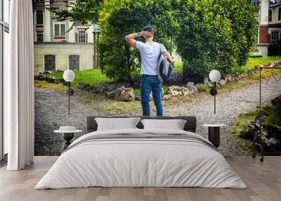 young man facing choice between two different paths Wall mural