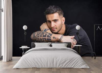 Young man with black t-shirt and tattoos Wall mural