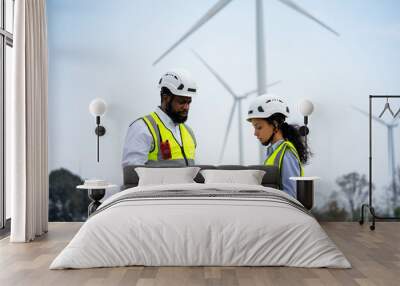 Engineer male and female on wind turbine farm. Two engineers discussed the plan for the maintenance of wind turbines. Wall mural