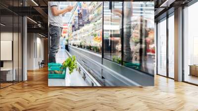 Men standing choose products in supermarkets, ready-to-eat food, shopping. Wall mural