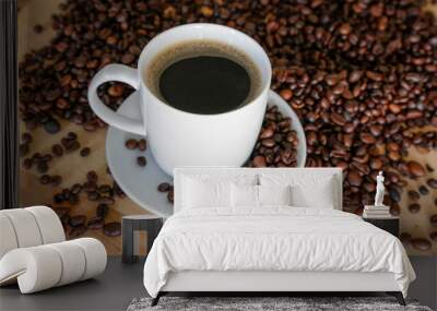  A cup of black coffee with coffee grains, natural light on wooden table Wall mural