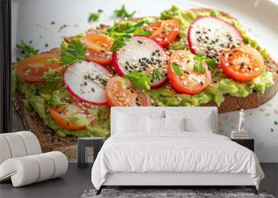 Artisanal sourdough bread topped with creamy avocado cherry tomatoes radish slices and black sesame seeds Wall mural