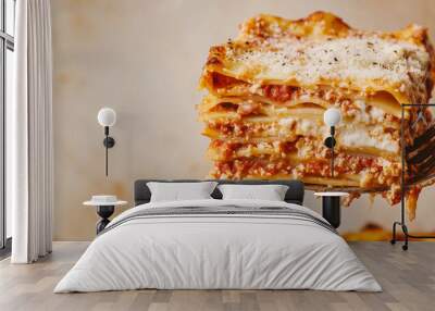 Slice of lasagna being lifted from the dish, revealing layers of pasta and sauce Wall mural