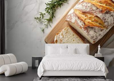 Whole ciabatta loaf on a wooden surface with slices next to it Wall mural