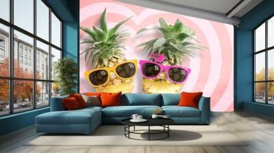 Couple pineapple wearing sunglasses on hearts pattern pink and red background with copy space and pastel tone. Wall mural