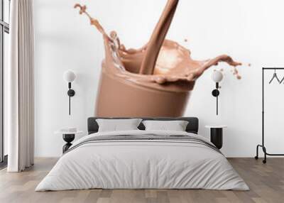 Pouring chocolate milk from bottle into glass with splashing., Isolated on white background. Wall mural