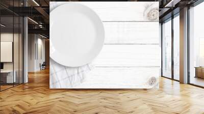 Top view of empty food plate put on tablecloth and wood table., All white object with copy space. Wall mural