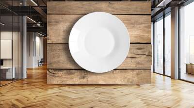 Top view of empty white food plate on a wooden background. Wall mural