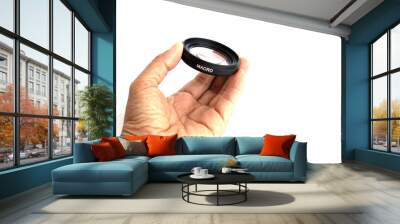 hand with lens on white background Wall mural