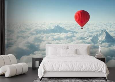 A lone red hot-air balloon flying high above the clouds, with the peaks of mountains visible below, against a bright morning sky. Wall mural