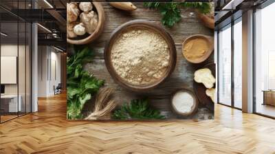 A rustic table filled with various organic ingredients, featuring maca powder as the centerpiece. Wall mural